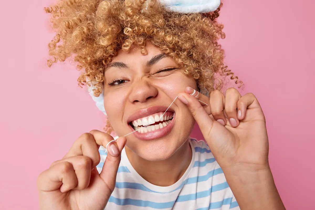 Woman flossing her teeth