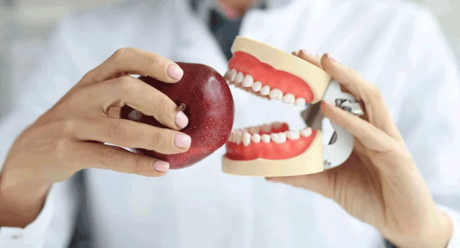 fake teeth biting an apple