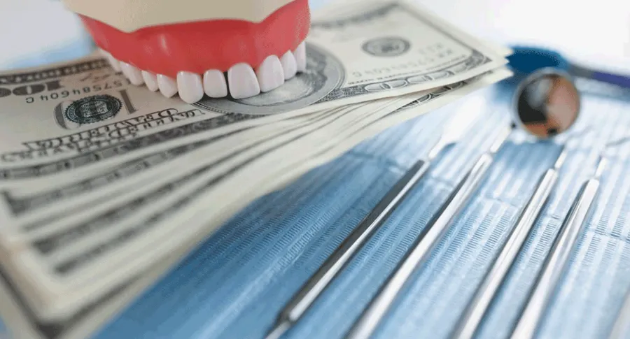 fake teeth holding money as a clip