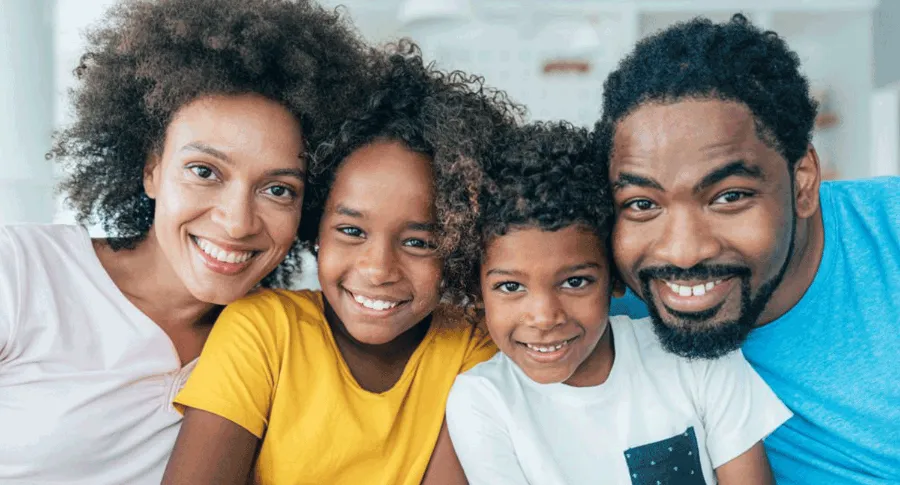 family of 4 showing their teeth