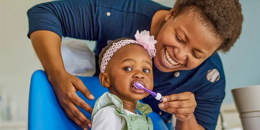 Mother brushing her child's teeth