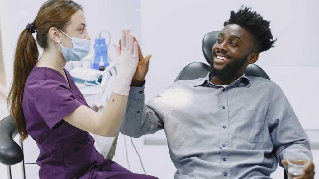 Dentist high 5 with patient