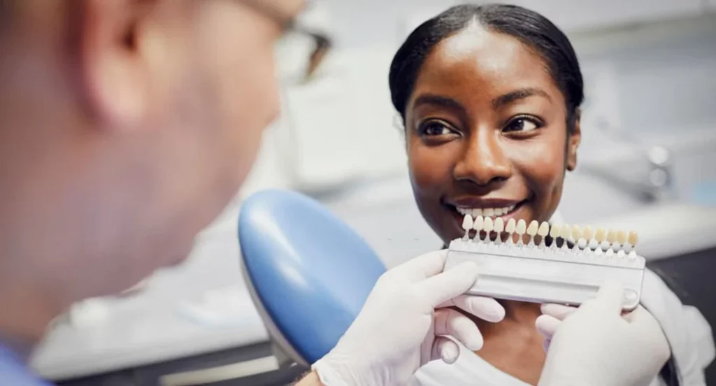 black woman getting her dental veneers sampled at the dentist