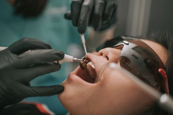 patient getting their teeth check at the dentist